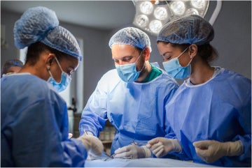 Nurses operating on patient