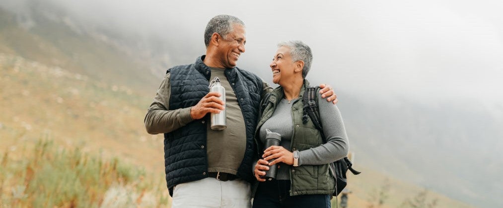 Senior couple hiking in the mountains in nature
